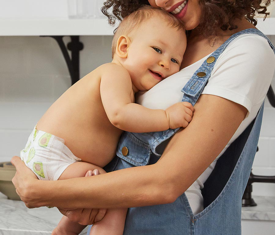 mom holding baby in kitchen